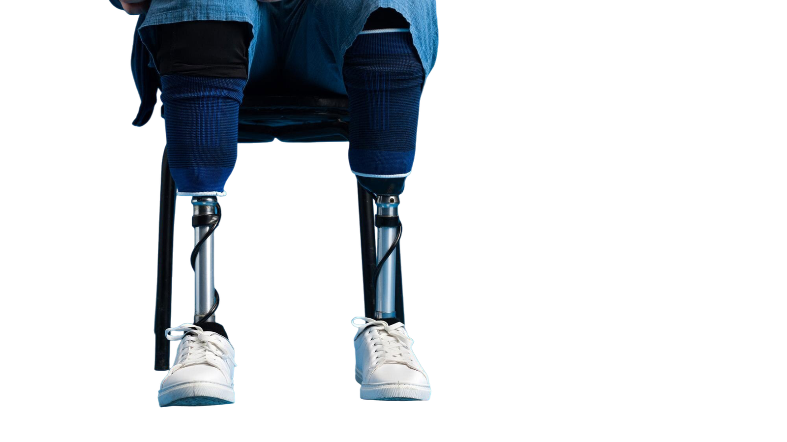 view-man-with-prosthetic-legs-white-sneakers-sitting-chair-blue-background